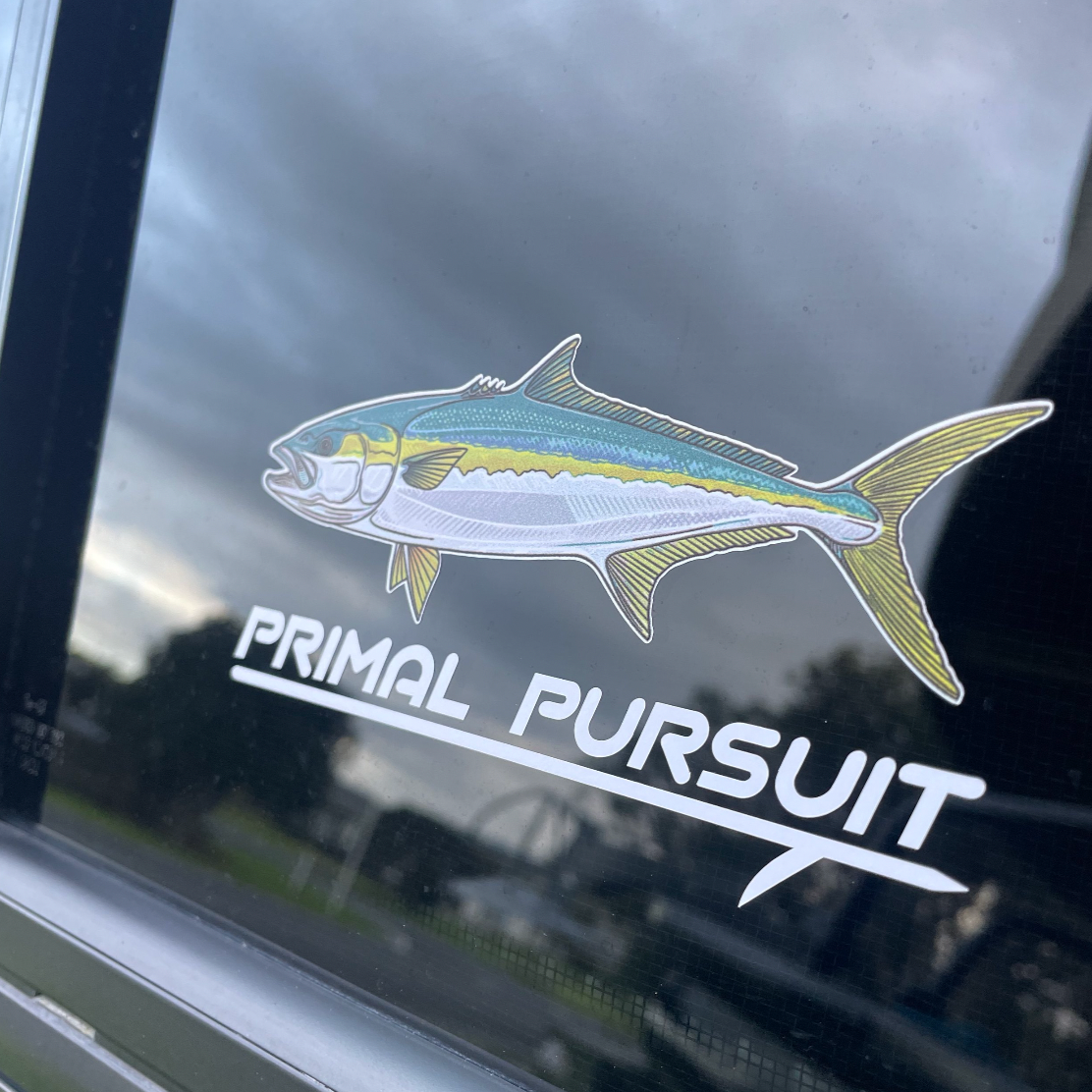Fish decal with 'Primal Pursuit' text on a car window